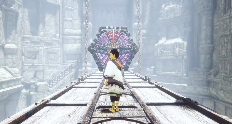 the player is stood in the middle of metal tracks on the ground and ahead, held up by chains, there is a hexagon of stained glass with an eye shape in the middle