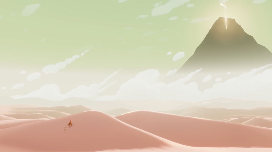 the tiny red cloaked player is walking up a sand dune towards a mountain in the far distance