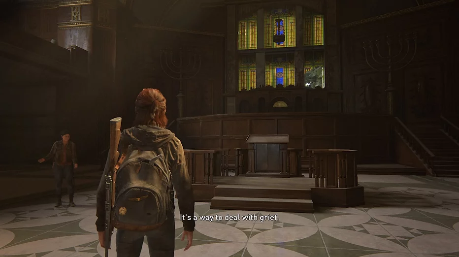Ellie stands in the centre of a synagogue where Dina is telling her about the place, and the caption on screen says &lsquo;it&rsquo;s a way to deal with grief&rsquo;