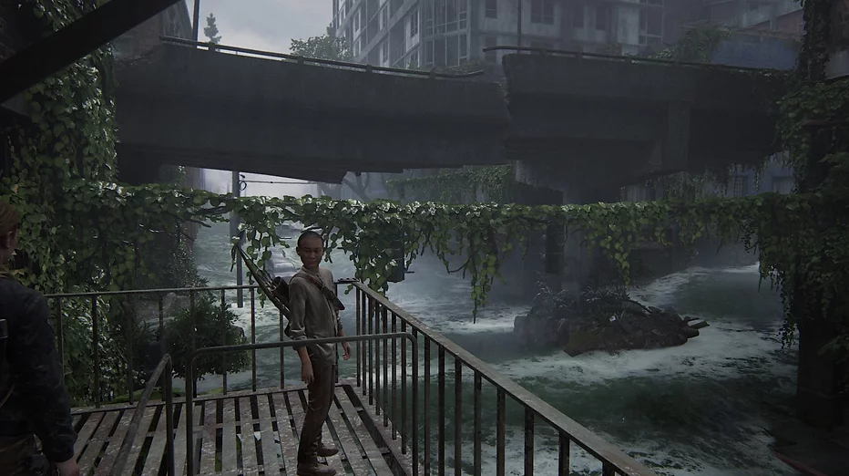 Lev stands on a stairwell next to a road that has become a river