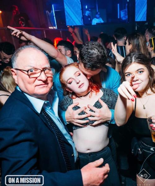 a photo in a nightclub shows a girl being felt up from behind by a man, another girl to one side pointing at the camera, and an old man on the other with his shirt undone