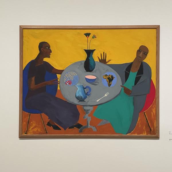 Two black people sit at a table eating food together. The style makes the perspective very flattened so that we can see everything on the table, the plates, bowl, jug, vase, cutlery, and the clothes the people are wearing are flattened down to single colours: turqoise dress under grey jacket, and black top and navy skirt