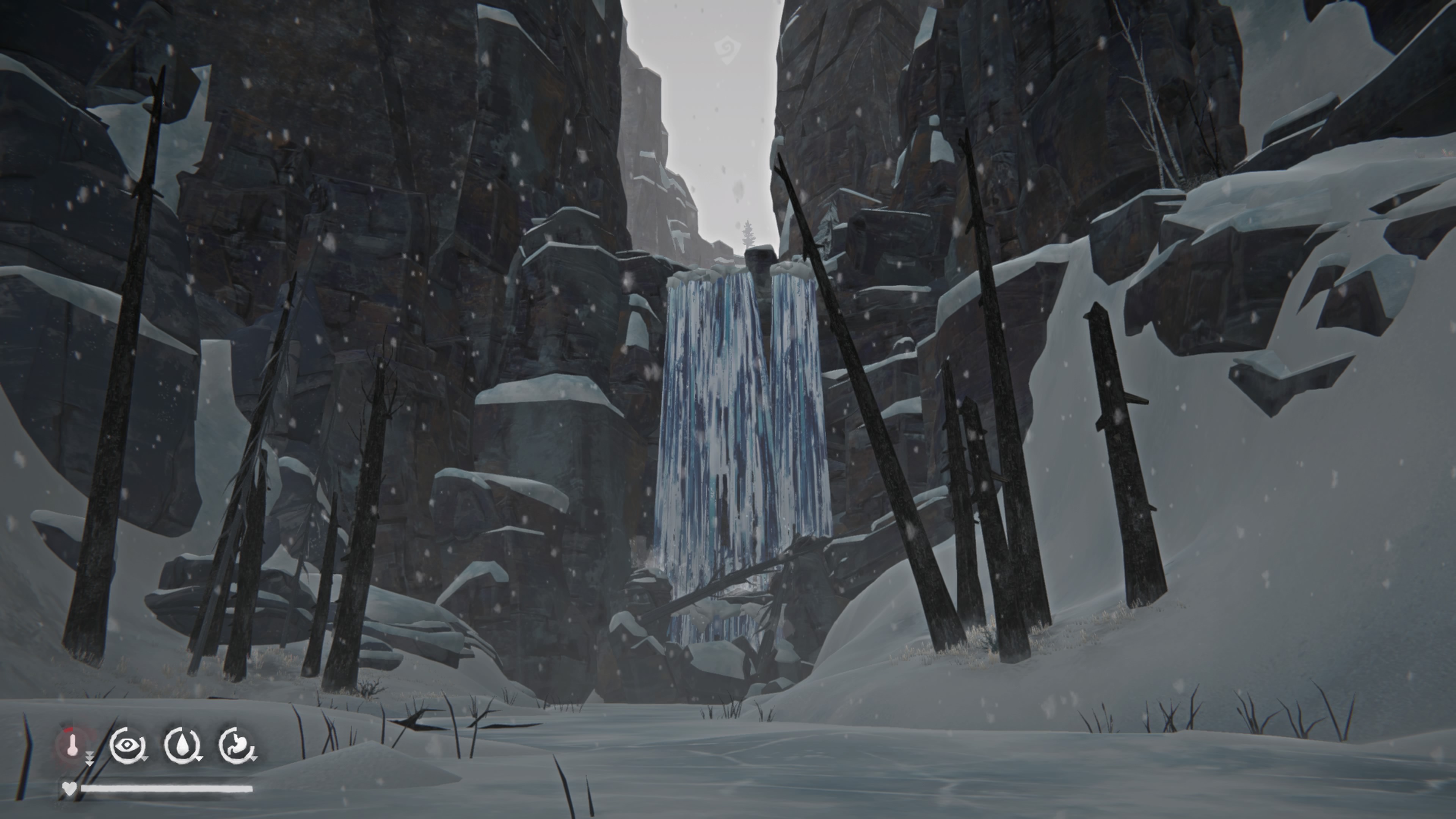 there's a waterfall between rocks in a snowy setting between bare tree trunks, and in the left hand corner on the screen there are four circles with icons inside them to track the temperature, energy, thirst and hunger of the character