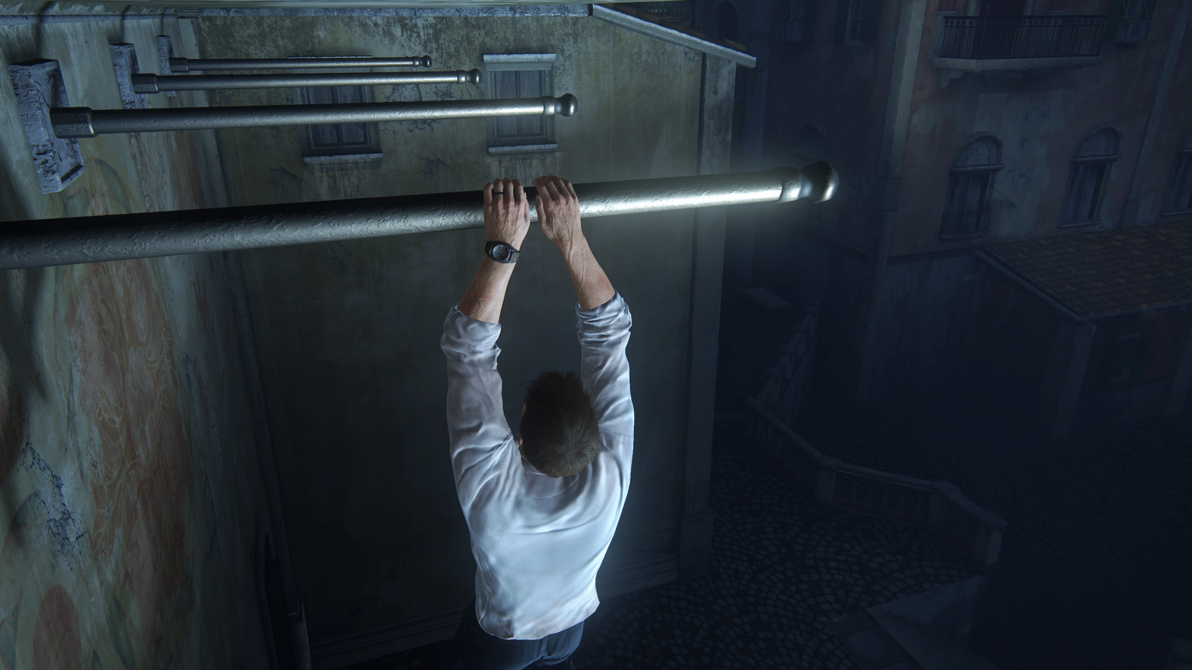 we can see the veins on nathan's hands straining as he hangs onto a pole on the side of a building, except it's strange because there is a whole row of these poles poking out of the side of the building, and they can't be flag poles because they are tucked away in a dark place, so it's literally just for the player to get across - and i hate that so much, it's so obvious
