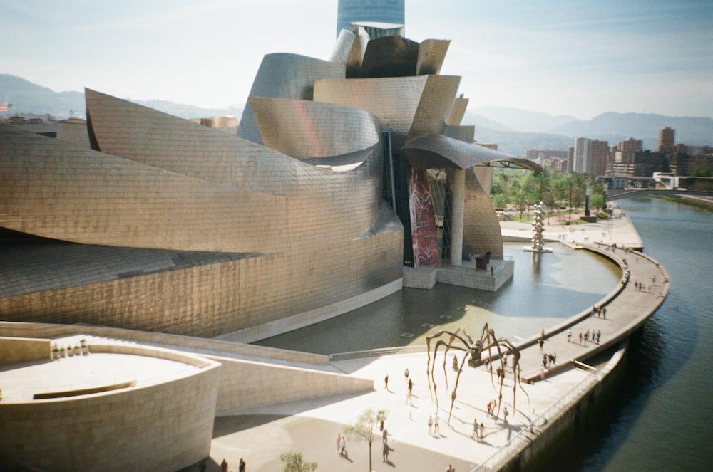 the guggenheim building bilbao which is silver and metallic with big ribboning shapes