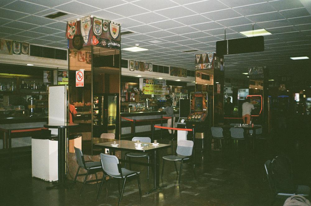 an old style rest stop in spain with roulette machines, a canteen and tables