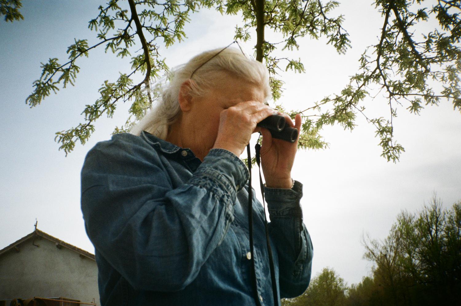 Anita looking through binoculars