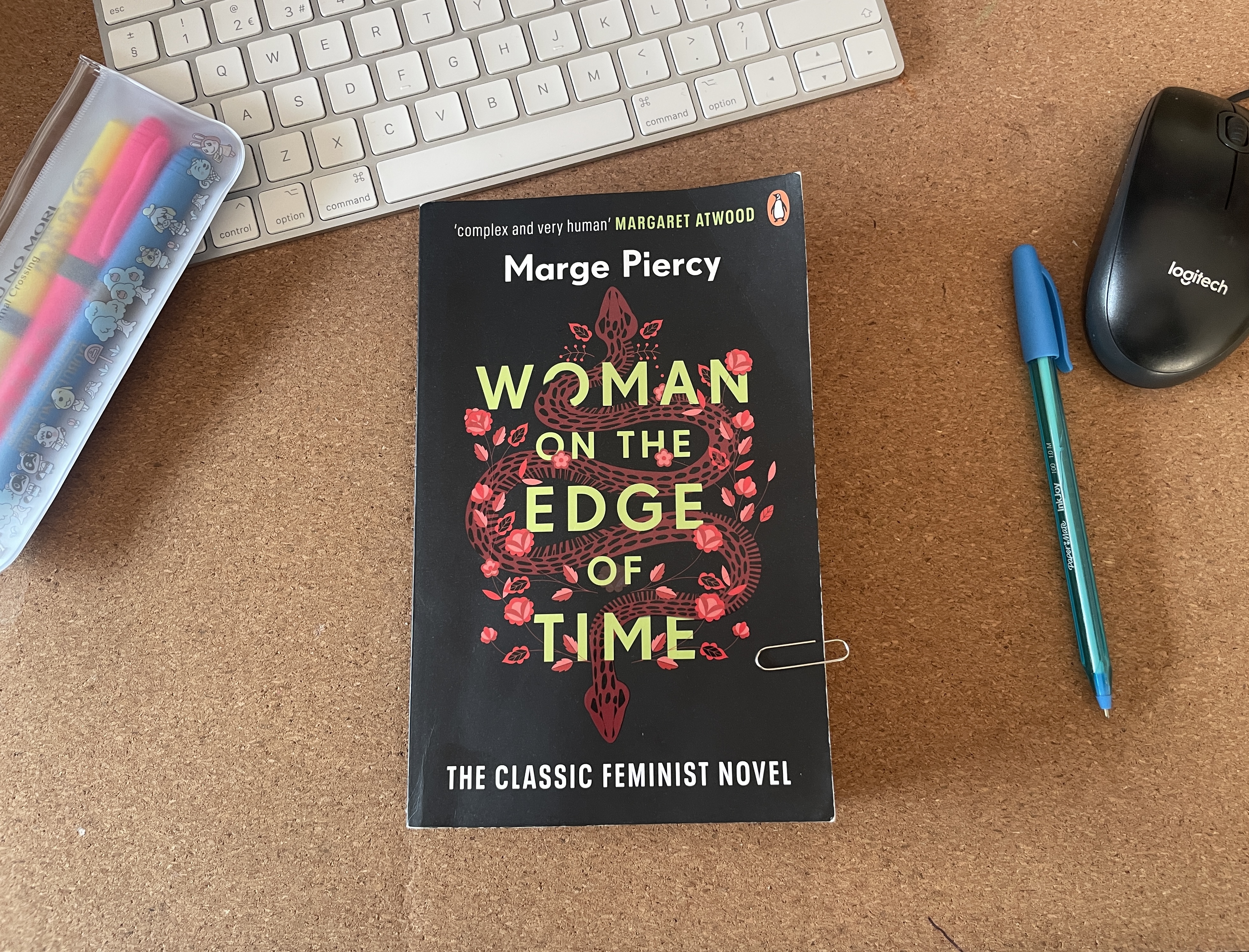 gab holding woman on the edge of time, a book by marge piercy, with a black cover and a red snake looping through the lettering